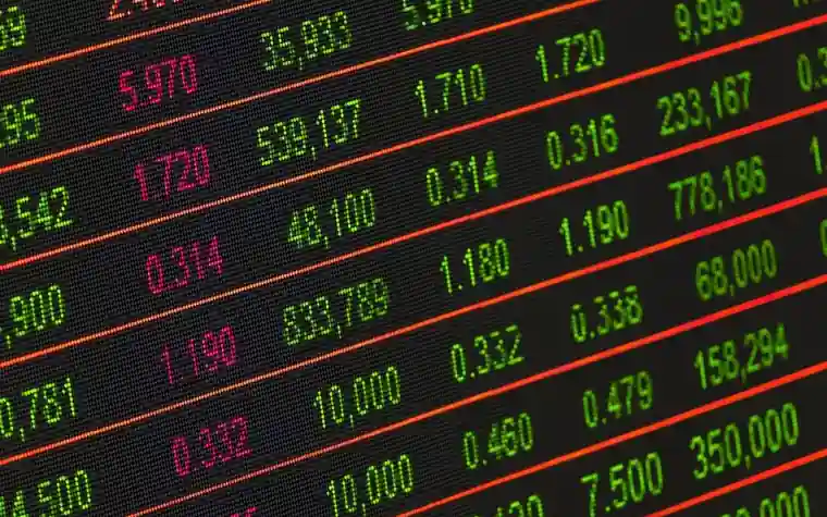 Red and green stock ticker board showing rows of scrolling market prices