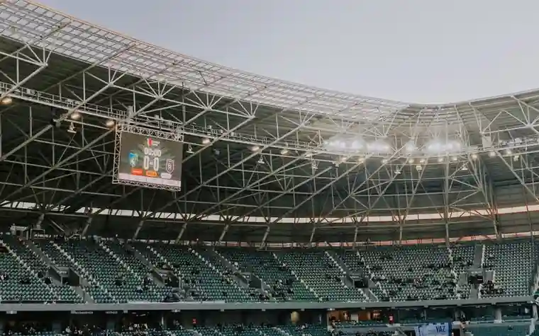 Modern illuminated sports stadium seating bowl at night