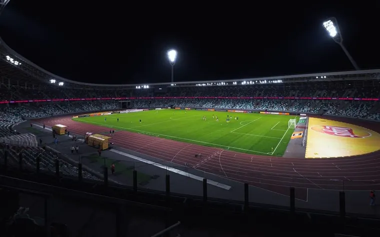 Empty lit soccer stadium at night