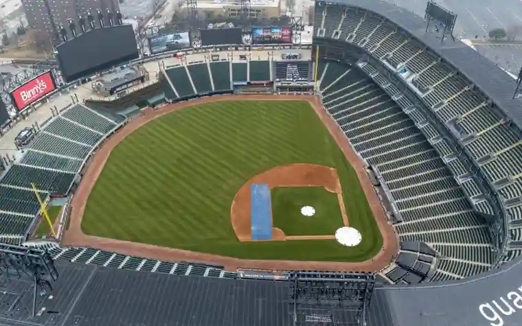 Aerial view of a baseball stadium with a blue tarp covering part of the infield