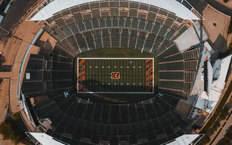 Aerial view of an empty American football stadium showing the painted yard lines and end zones