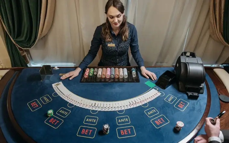 Casino dealer managing a baccarat table