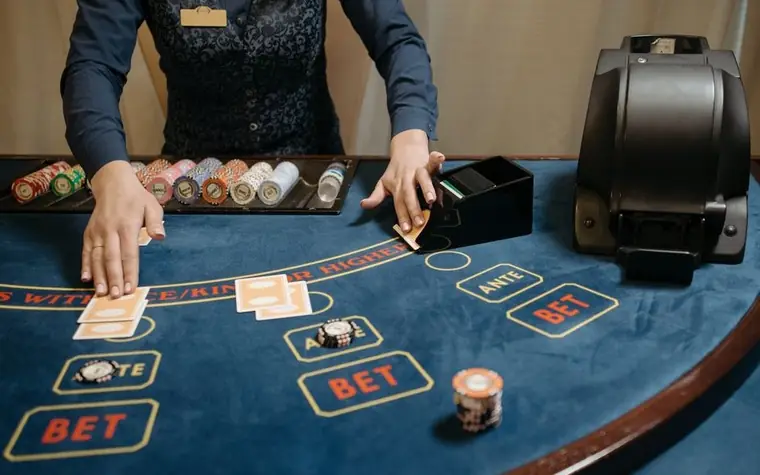 Casino dealer organizing cards and chips
