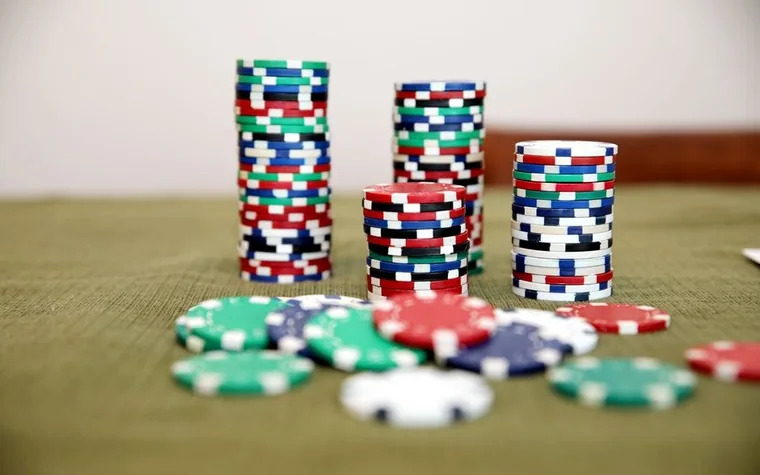 Stacks of poker chips on a green felt table