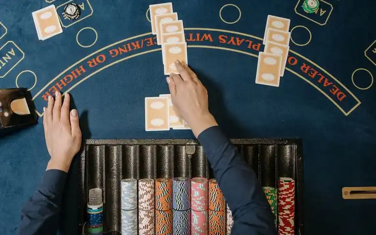 Dealer distributing cards at a blackjack table