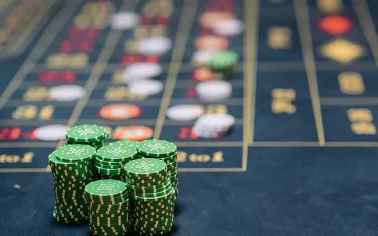 Stack of green casino chips on a table