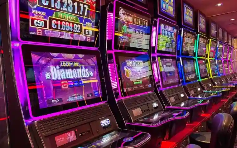 Row of colorful slot machines with neon lights