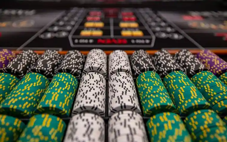 Close-up of colorful casino chips arranged on a table