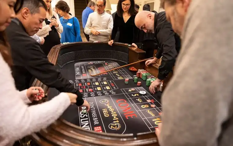 Players gathered around a casino craps table during a game