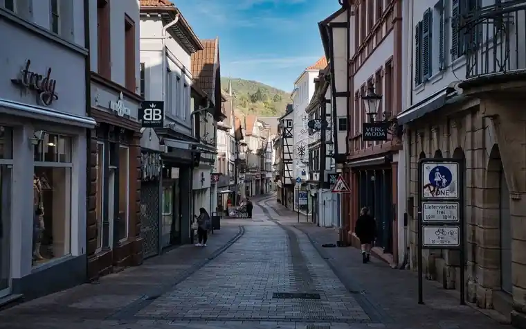 Cobblestone pedestrian street lined with half-timbered buildings in a small German town