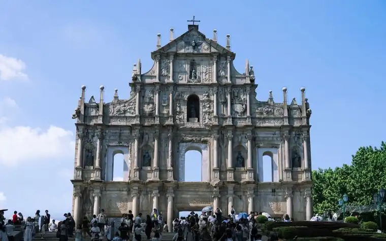 Stone facade of the Ruins of St Paul's in Macau under a clear blue sky
