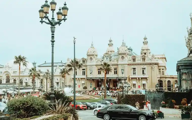 Ornate Belle Époque facade of the Casino de Monte-Carlo with classic cars parked outside