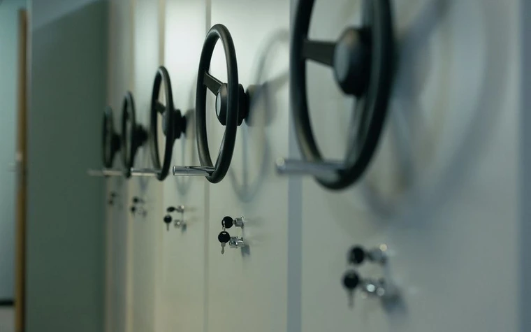 row of wheel-lock handles and small key locks on a bank of mobile storage cabinets