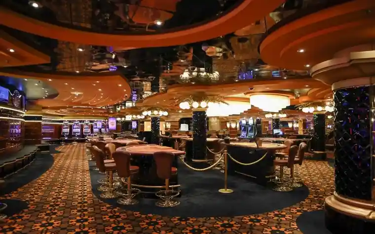 Elegant casino floor interior with slot machines and ornate ceiling lighting
